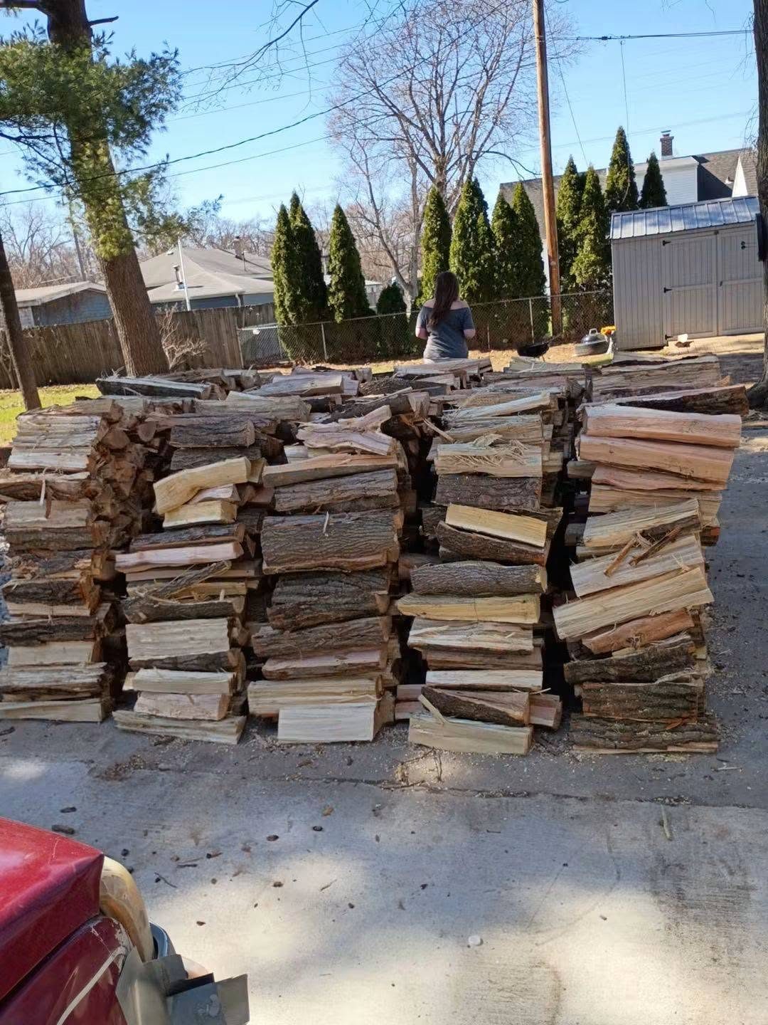 Rows of split firewood stacked in the T's Trees yard